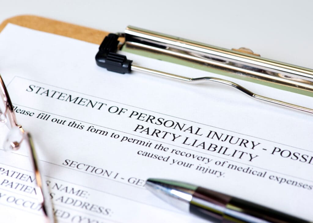 close up of clipboard with paperwork that starts to say, “Personal Injury Statement”