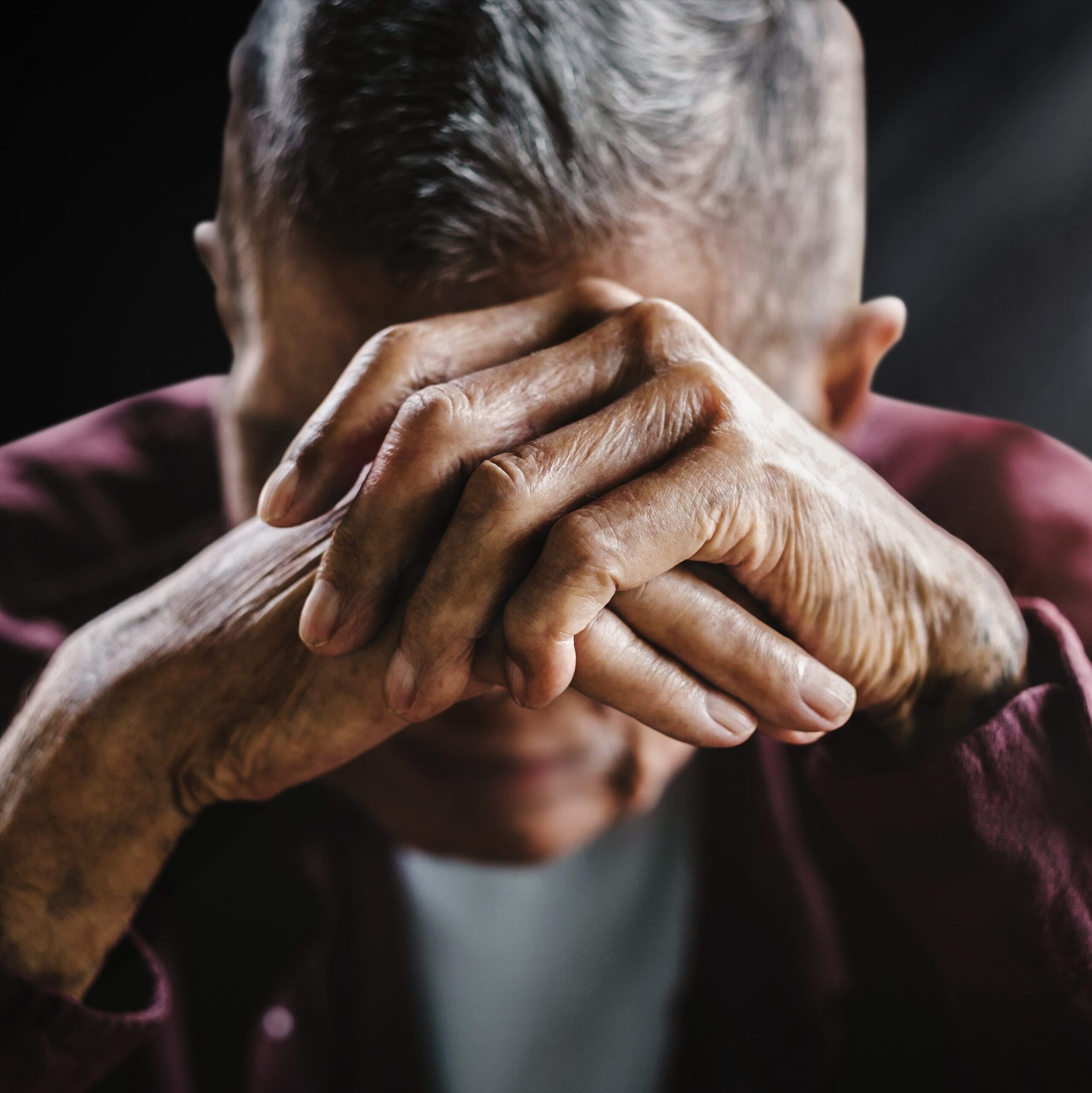 senior man covering his face with his hands. Depression and anxiety