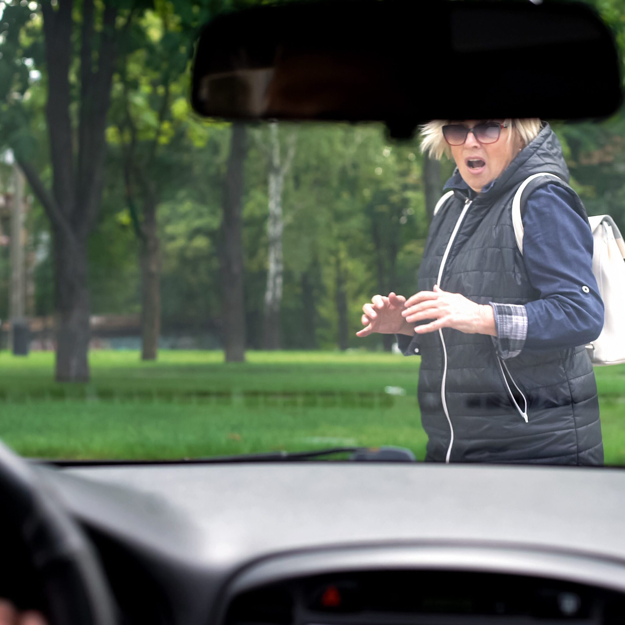 Driving car stopping front of scared pedestrian
